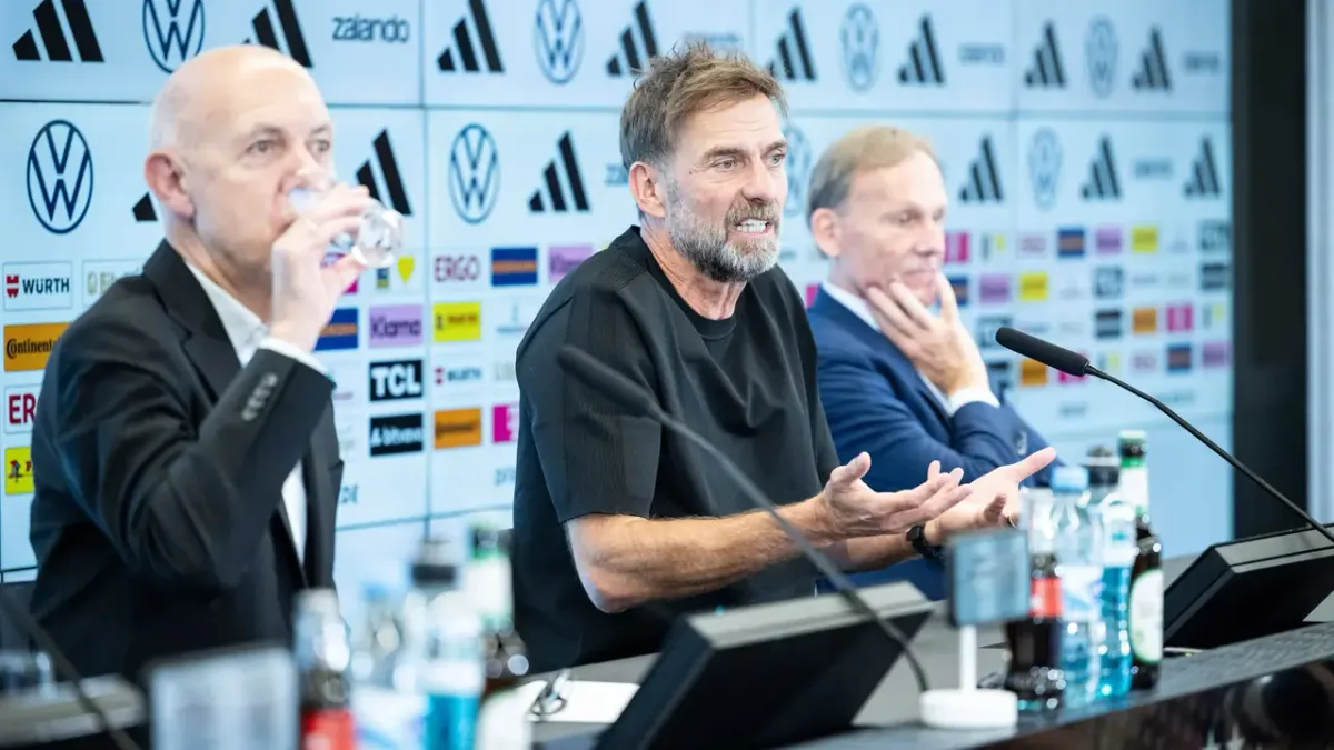 Jürgen Klopp speaks at his first press conference as Germany head coach, DFB logo visible behind him